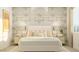 Bedroom featuring a decorative wallpapered wall, a plush bed with pillows, and stylish bedside tables at 17411 W Swayback Pass, Surprise, AZ 85387
