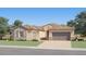 Charming single-story home with stone accents, a two-car garage, and a well-manicured lawn at 17411 W Swayback Pass, Surprise, AZ 85387