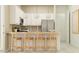 Open kitchen with an island, bar stool seating, modern light fixtures, and stainless steel appliances at 17411 W Swayback Pass, Surprise, AZ 85387