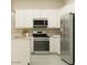 Bright kitchen with white cabinets, stainless steel appliances, and modern countertops at 17411 W Swayback Pass, Surprise, AZ 85387