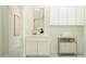 Functional laundry room with ample storage, modern cabinets, and convenient layout at 17411 W Swayback Pass, Surprise, AZ 85387