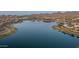 Expansive lake reflecting the sky, surrounded by lush greenery and a peaceful community, perfect for nature enthusiasts at 18135 W Hope Dr, Goodyear, AZ 85338