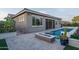 Backyard view featuring the pool, adjacent fire feature, and desert landscaping surrounding the home at 18135 W Hope Dr, Goodyear, AZ 85338