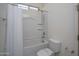 Bright bathroom features a tub-shower combination, modern fixtures, and a pristine toilet, offering a functional layout at 18135 W Hope Dr, Goodyear, AZ 85338