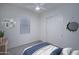 Staged bedroom with ceiling fan, window, closet, and tasteful decor at 18135 W Hope Dr, Goodyear, AZ 85338