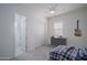 Modern bedroom with en suite bathroom, built-in closet, and window, offering comfort and style at 18135 W Hope Dr, Goodyear, AZ 85338