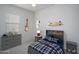 Cozy bedroom showcases a stylish bed, curated decorations, and a window, creating a welcoming and personalized space at 18135 W Hope Dr, Goodyear, AZ 85338