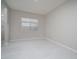 Empty bedroom with tile flooring, neutral paint, window, and recessed lighting at 18135 W Hope Dr, Goodyear, AZ 85338