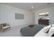 Staged primary bedroom with neutral carpet, ceiling fan, TV and modern decor at 18135 W Hope Dr, Goodyear, AZ 85338