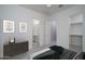 A staged bedroom with ensuite bathroom and walk-in closet at 18135 W Hope Dr, Goodyear, AZ 85338