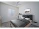 A well-lit bedroom featuring a cozy bed with gray furnishings and neutral wall art at 18135 W Hope Dr, Goodyear, AZ 85338
