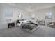 Staged bedroom featuring neutral carpet, windows with a view and stylish decor at 18135 W Hope Dr, Goodyear, AZ 85338