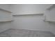 Walk-in closet featuring neutral carpet and built in shelving at 18135 W Hope Dr, Goodyear, AZ 85338