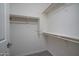 Spacious walk-in closet with white shelving and plenty of storage space at 18135 W Hope Dr, Goodyear, AZ 85338