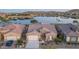 Stunning waterfront home featuring desert landscaping, tile roof, and attached two-car garage at 18135 W Hope Dr, Goodyear, AZ 85338