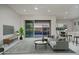 Open concept living room with tile flooring, furniture, and an outdoor view of backyard pool at 18135 W Hope Dr, Goodyear, AZ 85338