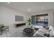 Living room with tile floors, neutral decor, and access to backyard pool area at 18135 W Hope Dr, Goodyear, AZ 85338