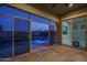 Covered patio overlooking a pool and lake with lush landscaping at 18135 W Hope Dr, Goodyear, AZ 85338