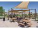 Shaded community playground with picnic benches, playground equipment, and desert views at 18135 W Hope Dr, Goodyear, AZ 85338