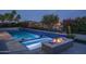 Backyard pool with spa and water feature plus view of lake at 18135 W Hope Dr, Goodyear, AZ 85338
