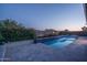 Beautiful backyard pool with colorful plantings and view of lake at 18135 W Hope Dr, Goodyear, AZ 85338