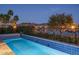 Serene pool with lake view, set against a backdrop of lush greenery at 18135 W Hope Dr, Goodyear, AZ 85338