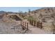 Scenic community walking trail featuring a bridge and steps leading to higher ground at 18135 W Hope Dr, Goodyear, AZ 85338