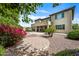 Charming backyard with mature flowering landscaping, decorative rocks and covered patio at 19242 W Pasadena Ave, Litchfield Park, AZ 85340