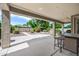 Covered patio with landscaped backyard and beautiful blooming trees at 19242 W Pasadena Ave, Litchfield Park, AZ 85340
