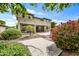 Well-manicured backyard with mature flowering landscaping and covered patio at 19242 W Pasadena Ave, Litchfield Park, AZ 85340
