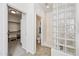 Well-lit bathroom featuring a glass block shower and access to walk-in closet and water closet at 19242 W Pasadena Ave, Litchfield Park, AZ 85340
