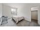 Bright bedroom with a window view and a closet, featuring a simple desk, lamp and minimal decoration at 19242 W Pasadena Ave, Litchfield Park, AZ 85340