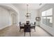 Elegant dining area features neutral colors, modern chandelier lighting, and an arched doorway at 19242 W Pasadena Ave, Litchfield Park, AZ 85340