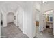 Arched hallway leads to an elegantly appointed bathroom and a grand entrance at 19242 W Pasadena Ave, Litchfield Park, AZ 85340