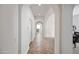 Hallway boasts archways leading to dining room and living room, neutral colors, and warm tile flooring at 19242 W Pasadena Ave, Litchfield Park, AZ 85340