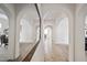 Hallway features beautiful arches that lead to the living room, dining area, and front of the home at 19242 W Pasadena Ave, Litchfield Park, AZ 85340