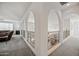 Hallway with architectural arches that provide views between the upstairs living spaces at 19242 W Pasadena Ave, Litchfield Park, AZ 85340