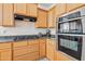 Kitchen with granite counters, wooden cabinetry and gas cooktop at 19242 W Pasadena Ave, Litchfield Park, AZ 85340
