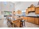 Well-lit kitchen with granite counters, an island and tile flooring at 19242 W Pasadena Ave, Litchfield Park, AZ 85340