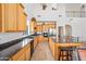 Bright eat-in kitchen with granite counters, an island and stainless steel appliances at 19242 W Pasadena Ave, Litchfield Park, AZ 85340