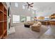 Bright open-concept living room with soaring ceilings and a cozy fireplace at 19242 W Pasadena Ave, Litchfield Park, AZ 85340