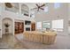 Grand living room with soaring ceilings, built-in shelving, fireplace, and large windows for natural light at 19242 W Pasadena Ave, Litchfield Park, AZ 85340