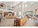 Bright living room boasts high ceilings, kitchen island, and balcony overlooking entertainment center at 19242 W Pasadena Ave, Litchfield Park, AZ 85340