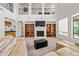 Bright living room boasts a fireplace, custom built-ins, and soaring ceilings for an open and airy feel at 19242 W Pasadena Ave, Litchfield Park, AZ 85340
