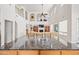 Bright living room boasts high ceilings, kitchen island, and balcony overlooking entertainment center at 19242 W Pasadena Ave, Litchfield Park, AZ 85340