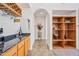 An elegant wet bar features granite countertops, custom cabinetry, and a wine glass rack for sophisticated entertaining at 19242 W Pasadena Ave, Litchfield Park, AZ 85340