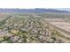 Breathtaking aerial view of a thriving community complemented by desert landscapes, a nearby highway, and picturesque mountain views at 20412 W Thayer St, Buckeye, AZ 85396