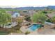 Aerial view of the home and landscaped backyard with sparkling pool, fire pit and gorgeous neighborhood at 20412 W Thayer St, Buckeye, AZ 85396