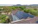 Aerial view shows home's tile roof with solar panels and a nearby community park, adding value at 20412 W Thayer St, Buckeye, AZ 85396