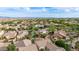 Extensive aerial view of a suburban neighborhood featuring a mix of single-Gathering homes with mature trees and private pools at 20412 W Thayer St, Buckeye, AZ 85396